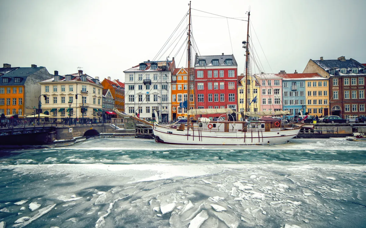 Historische bunte Gebäude und gefrorenes Wasser am Nyhavn in Kopenhagen im Winter.