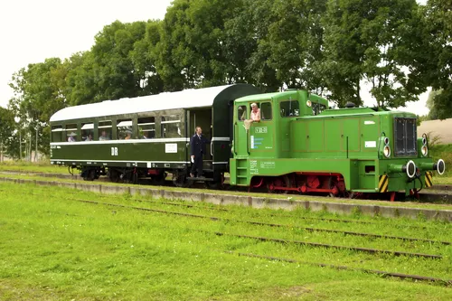 Grüne Museumsbahn mit Personenwaggon auf einem Gleis in Gramzow.