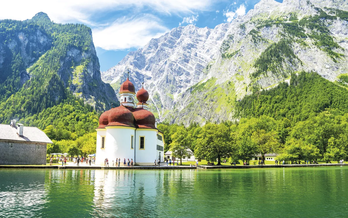Konigsee lake with st Bartholomew church surrounded by mountains