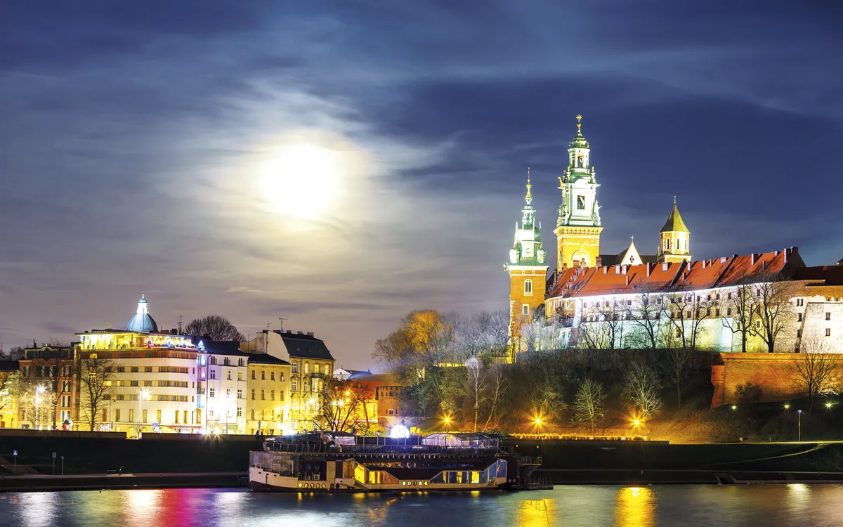 Full moon over Wawel Castle in the night in Krakow, Poland